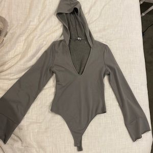 NEVER WORN: army green hooded bodysuit with bell sleeves from Tobi. Size large